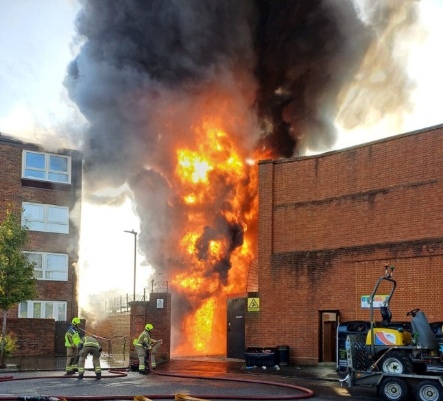 Flames and black smoke rising into the air at an electrical substation fire in Maida Vale, west London, with flames reaching a nearby block of flats on Aberdeen Place.